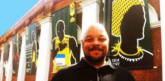 PROUD: Jon Daniels with the Jamaica 50 images he designed on Coldharbour Lane, Brixton