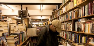 man browsing bookstore