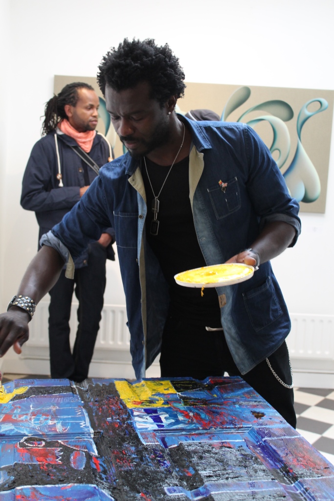 Adjani Okpu-Ekbe paints at the Knight Webb Gallery. Photograph by Ruth Waters