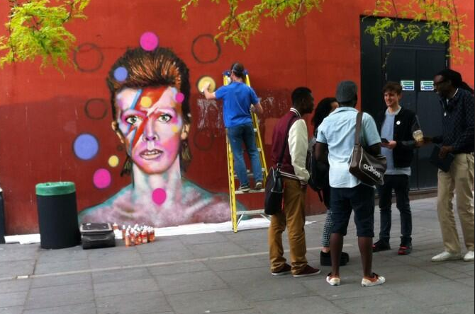Artist Jimmy Cochrane at work on the Brixton Bowie mural in 2013