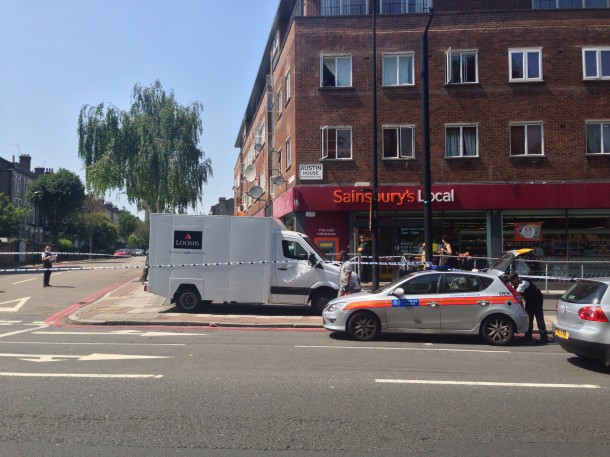Police seal off the area around the cash in transit van on Brixton Hil this afternoon. Picture by James Cornish