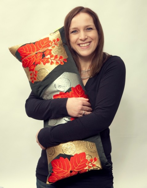 Ellie Laycock with one of her handmade cushions. Photograph by Studio 73, Brixton Village.