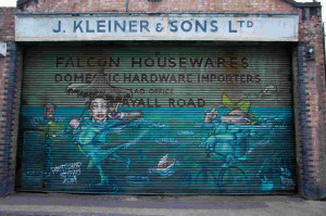 A piece on a shutter outside a garage by Paintshop Studio, on Mayall Road
