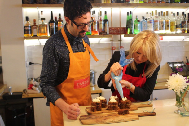 Esther McVey has a go at icing cakes under the watchful eye of Spyros Parissis