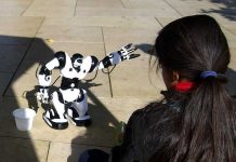 Girl playing with robot