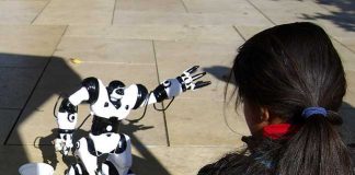 Girl playing with robot