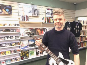Brixton store - Russell Lewendon with guitar (landscape)