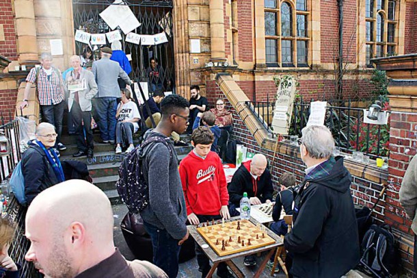 Members of Carnegie's free weekly chess club played outside on the steps