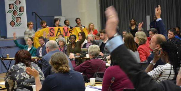 Protesters look on as councillors vote for the libraries plan at a council meeting earlier this year