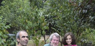 John (centre) with neighbours Manouchehr and Sonia bagging the grapes