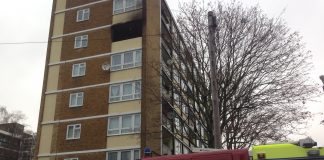 A fire engine can be seen outside a blackened fifth-floor flat