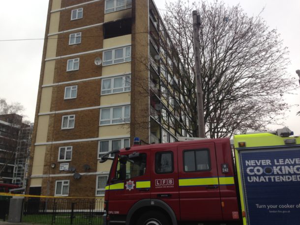 A fire engine can be seen outside a blackened fifth-floor flat