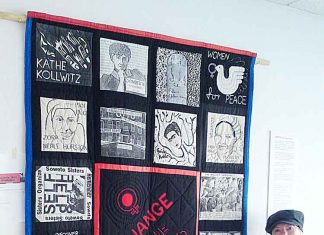 Teri Bullen hanging her historic patchwork of revolutionary women – Change the World! At the Brixton Calling! Exhibition in the 198 Gallery in 2011. Picture: Stefan Szczelkun/Flickr/Creative Commoms