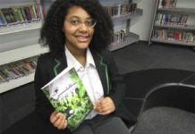 Student Micah with her book which tops Amazon best seller list