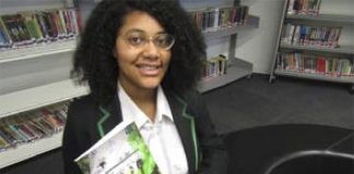 Student Micah with her book which tops Amazon best seller list