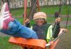 Child on swing at Max Roach Park