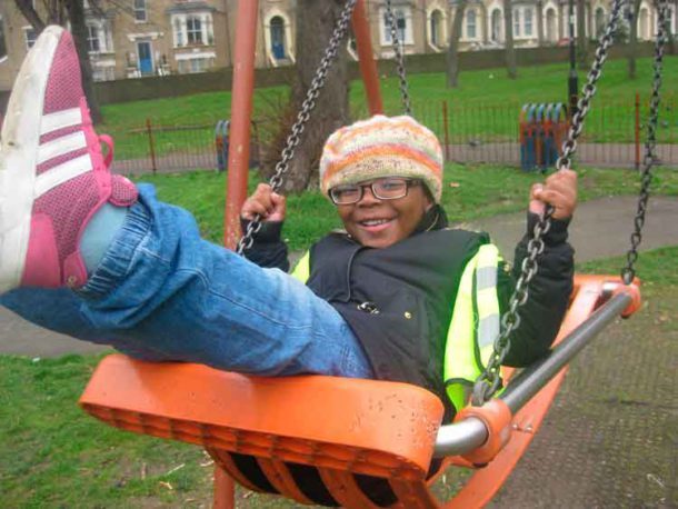 Child on swing at Max Roach Park