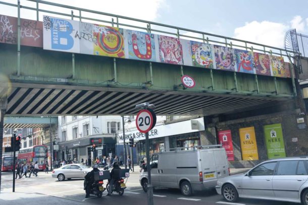 Bridge over Brixton Road with BE OUR Guest slogan