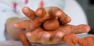 Child's hands with clay