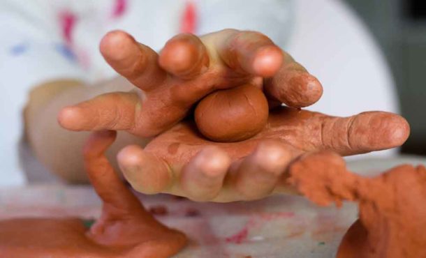 Child's hands with clay