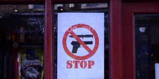 Stop knife gun sign in Brixton shop window