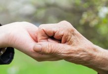 photo of two hands together to illustrate carer support