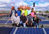 volunteers with solar panels