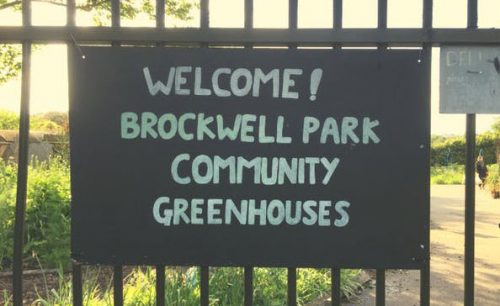 sign reading welcome to brockwell park community greenhouses