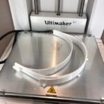 An Ultimaker 3D printer and the visor frame it is producing