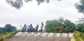 BMX riders at top of ramp