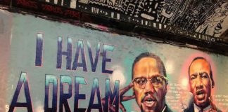 graffiti artist with images of MLK and Malcolm X