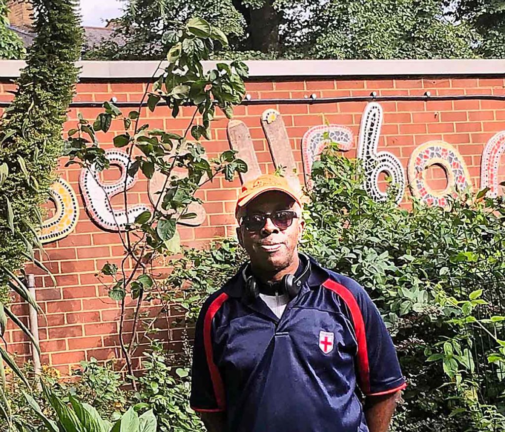 man in front of garden wall