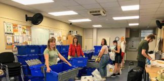 volunteers loading crates