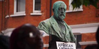 statue with sign