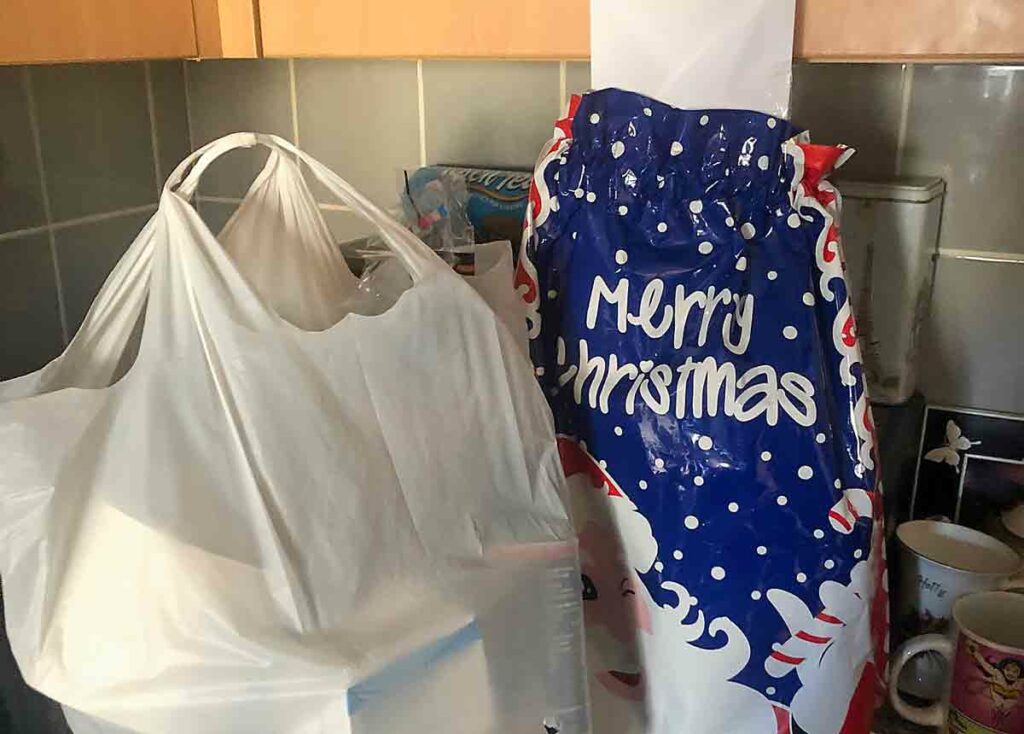 shopping bags, one marked Merry Christmas