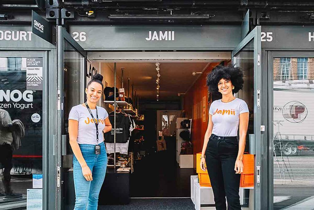 Two women in front of shop