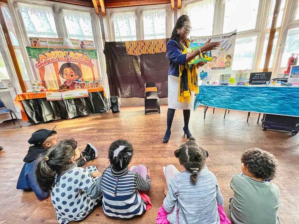 woman reading to audience of small children