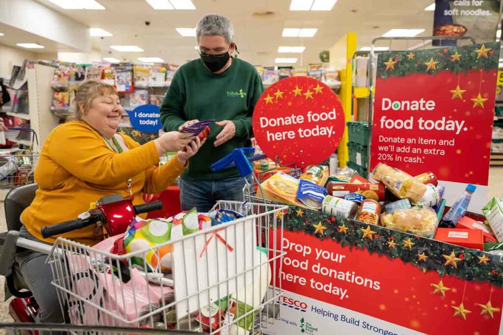 Woman donating food in a supermarket