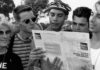 group of men read a pamphlet