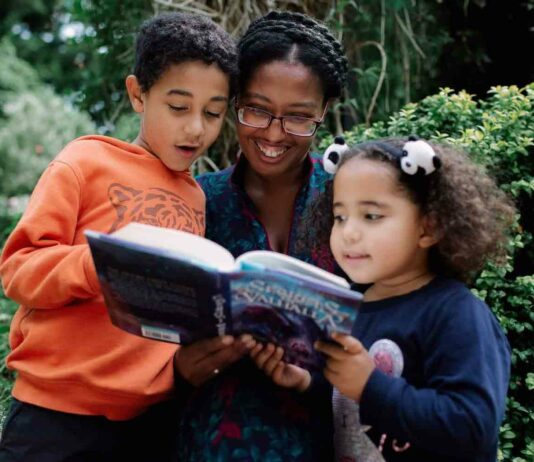 woman and children reading book