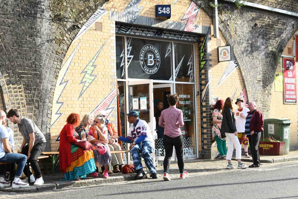 people outside a railway arch brewery outlet