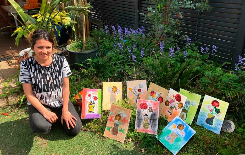woman in garden with artworks
