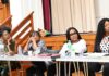 women on panel at public meeting