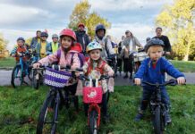 children and parents with bicycles