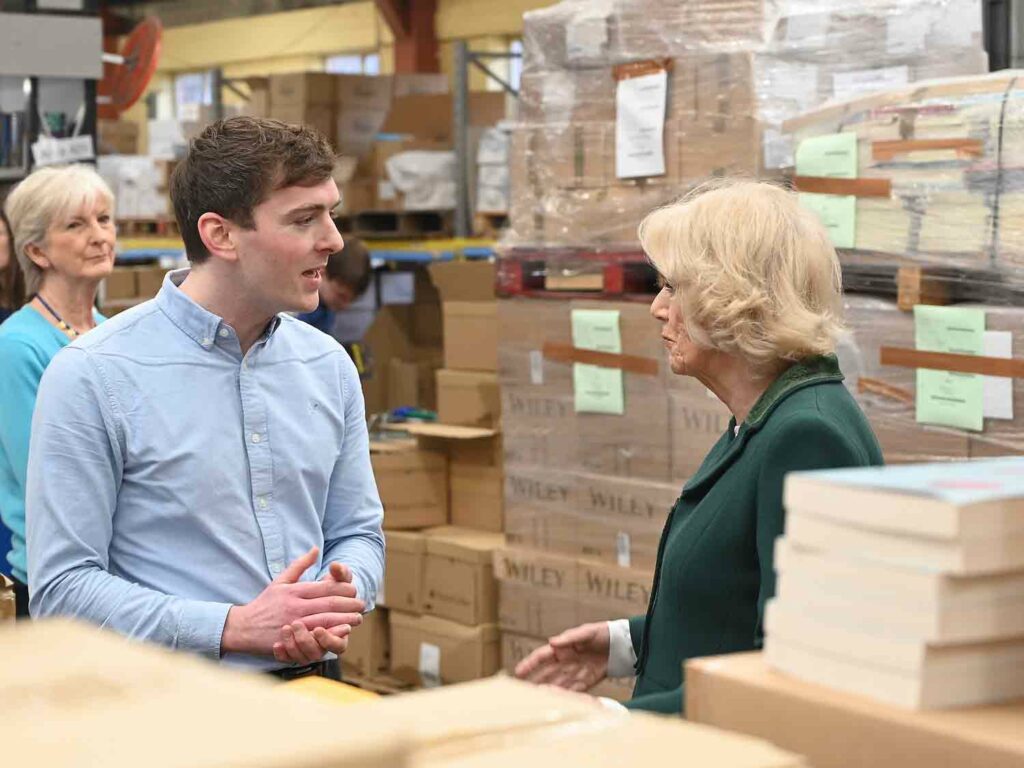 man and woman talk in book warehouse