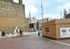 urban street scene with giant shoebox installation