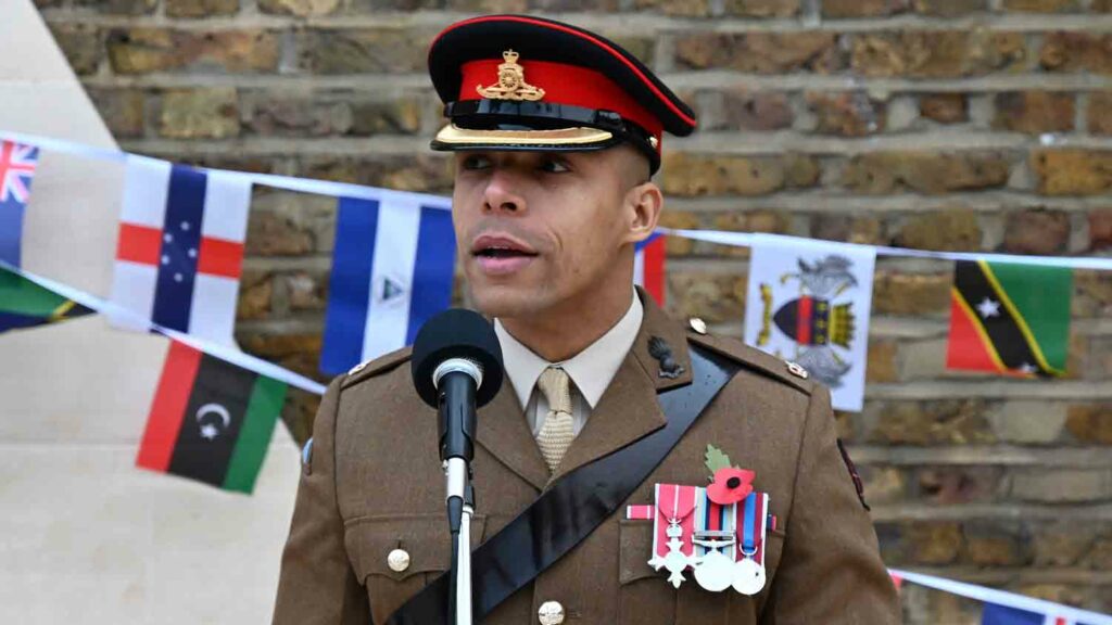 man in military uniform speaks into mic