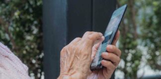 old hands holding smartphone