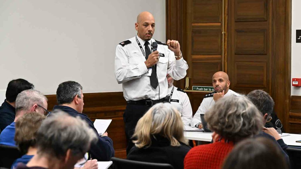 police officer addresses public meeting