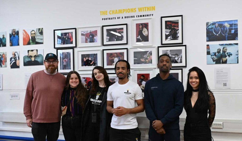 Group poses for photograph at an exhibition